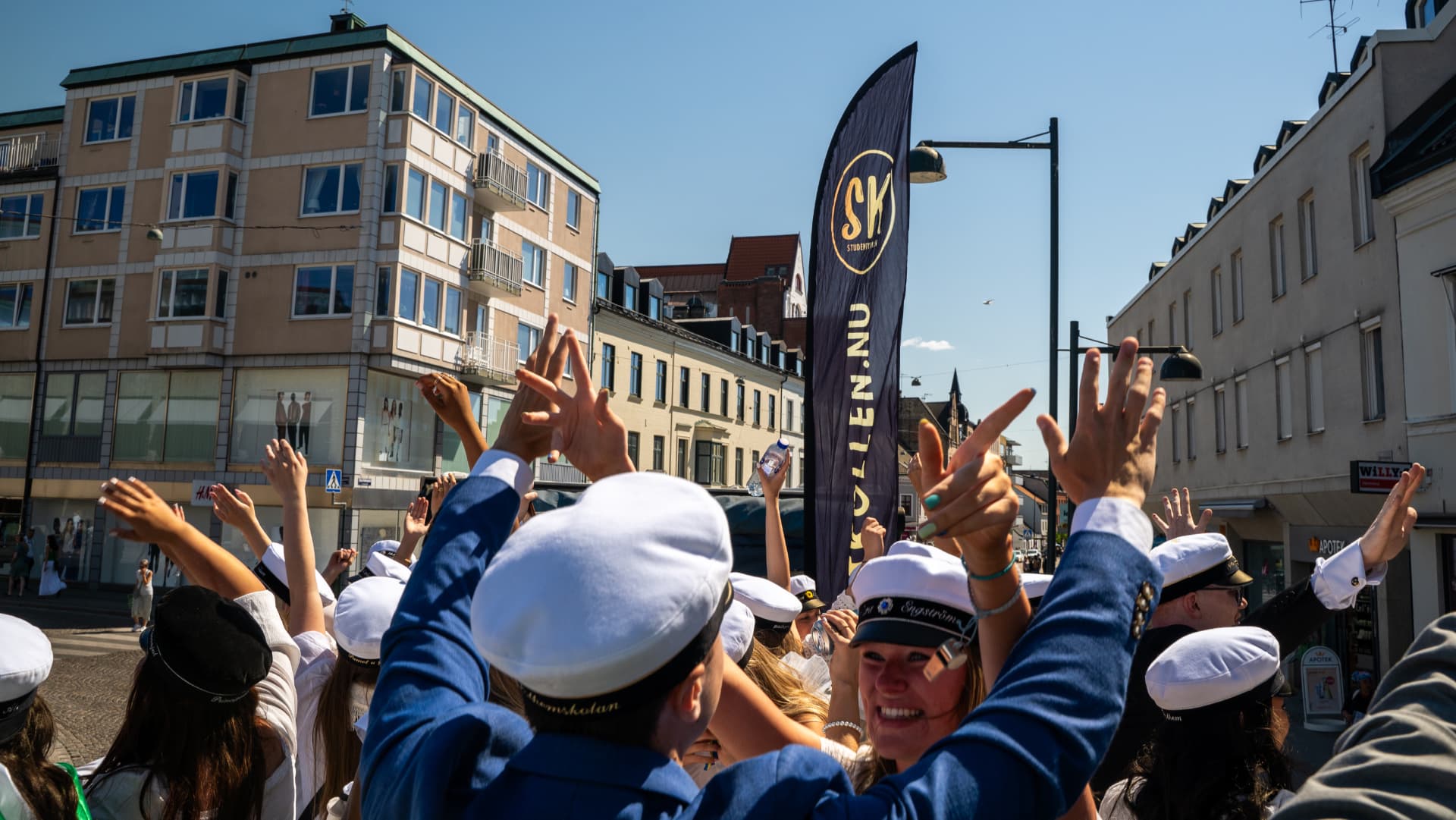 Jublande studenter med studentmössor på ett studentflak i Skåne